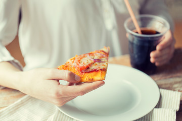 close up of woman with pizza and cola drink