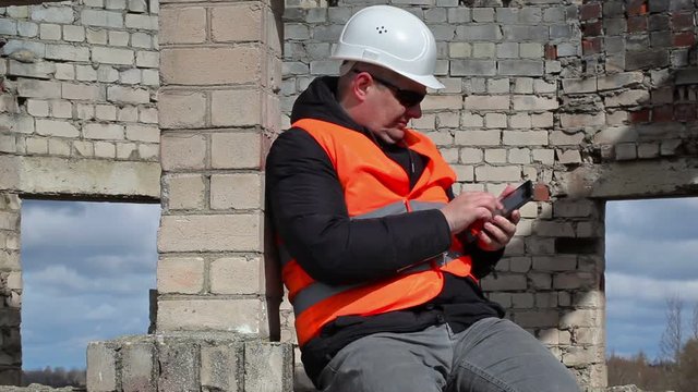 Civil engineer sitting and take pictures on tablet PC