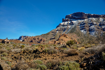 Ermita de Nuestra Senora de las Nieves chapel at the bottom of snow covered mount Guajara on the edge of Teide volcano caldera 
Roques de Garcia, Teide National park, Tenerife, Canary islands, Spain