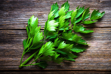 Lovage herb on wooden background