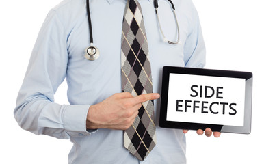 Doctor holding tablet - Side effects