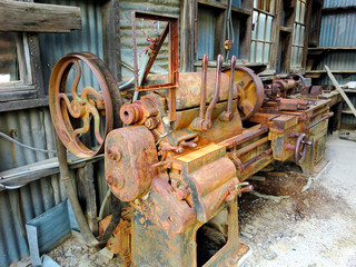 Vintage old rusty metal machine shop lathe - landscape color photo