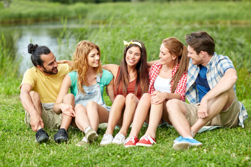 Fototapeta premium group of smiling friends talking outdoors