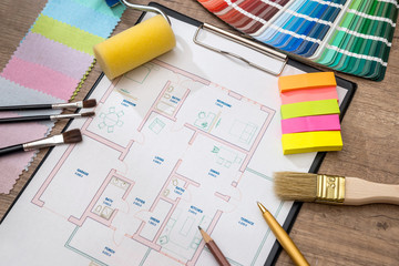 house plan with construction instruments, and color sample, paint brushes