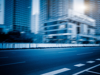 clean city road against blurred office buildings,blue,toned,image.