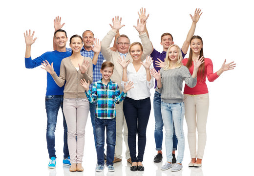 group of smiling people waving hands