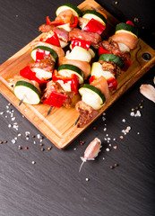 Preparing food for cooking barbecue on skewers on black stone