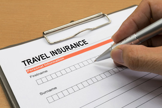 man signing a travel insurance policy