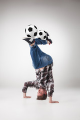 Portrait  of young man, practicing yoga with football balls