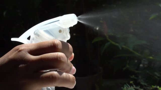 Using spraying bottle and cleaning on black background shooting with high speed camera 120 FPS.