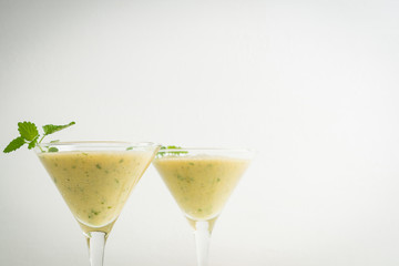 Fresh banana cocktail with mint on the wooden background