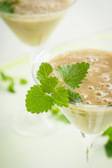 Fresh banana cocktail with mint on the wooden background