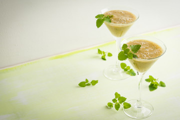 Fresh banana cocktail with mint on the wooden background