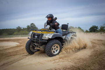 Racing ATV is sand.