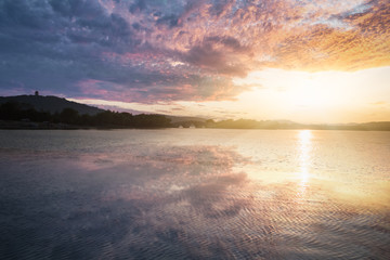 amazing gold sunset over a mountain lake.