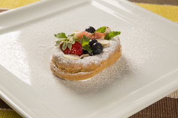 fresh fried pumpkin churros with red fruits on plate