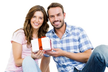 Happy young couple holding gift