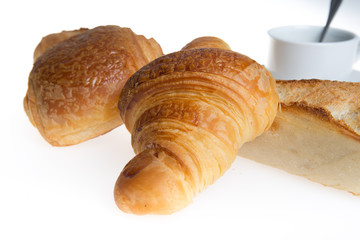 Cup of coffee with french croissant and chocolatine with bread