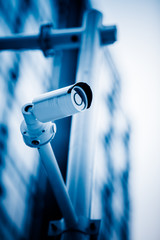 security camera in front of the office building,blue toned image.