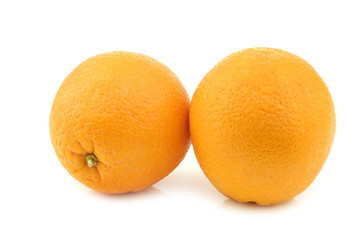 two fresh oranges on a white background