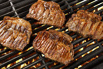 Delicious grilled meat over the coals on a barbecue