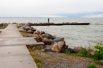 Fototapeta na wymiar Person Walking on the Pier