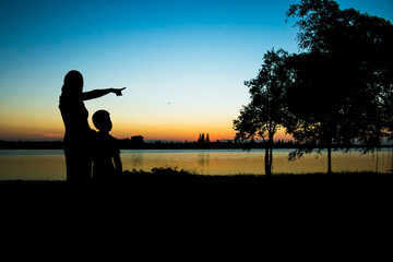 Silhouette Mother and son looking sunset