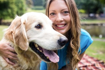 Smiling woman with her pet dog in park