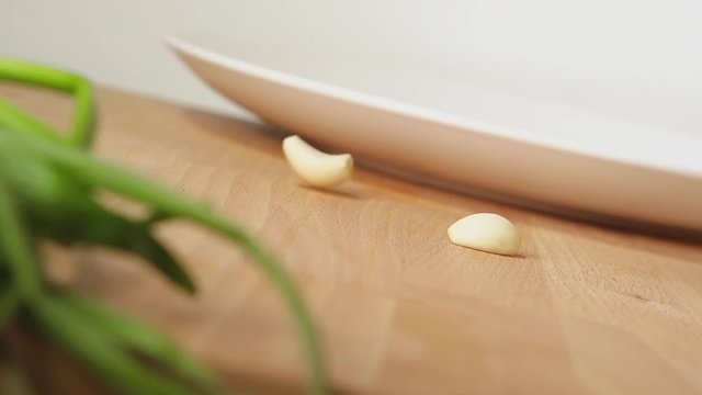 SLOW: A garlic falls on a table
