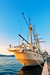 Fototapeta na wymiar Old sailing ship in sunset light