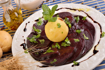 White dish with sliced beetroot and mint