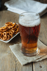 Glass of ale and snacks vertical