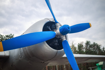 Naklejka na ściany i meble Closeup of propeller and engine of old vintage aircraft. Propeller of retro airplane. Selective focus on propeller.