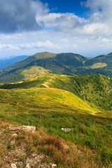 View of panoramic mountains landscape of a rocky cliffs and green hills.