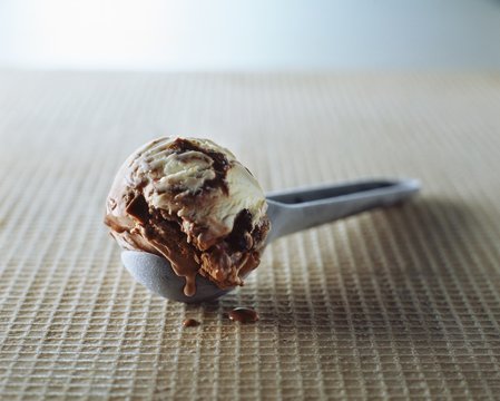 Chocolate chip and vanilla ice cream in metal scoop