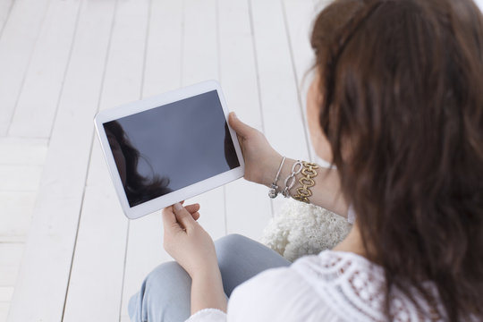 Mature woman with a tablet. View from above