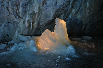 Ice stalagmites illuminated by candles inside the marble mine. Ruskeala, Karelia, Russia. - 109161686