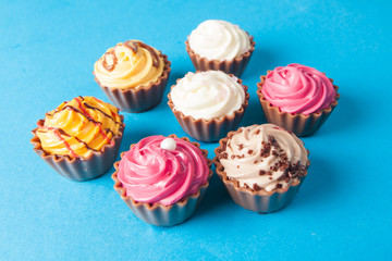 Birthday cupcakes on blue background. many sweet  cupcakes