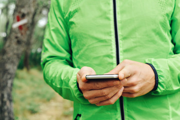 young sportsman using his smartphone