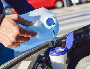 filling the tank of windshield washer fluid