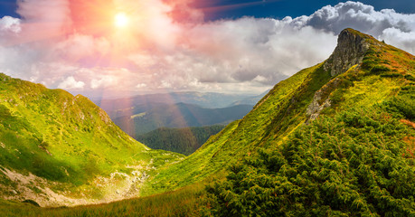 View of panoramic mountains landscape of a rocky cliffs and green hills.