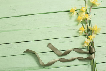 yellow flowers on green wooden background
