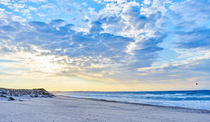 Kitesurfing on ocean at sunset in sardinia / Beach at north coast of Sardinia