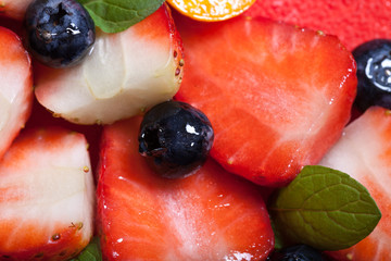 Many fresh berries on bright mousse cake
