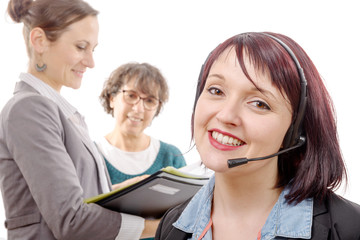 Close-up portrait of smiling young woman with headset