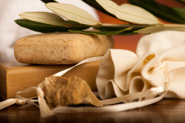 Olive oil soap  with a towel on a wooden desk