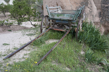 Old cart overgrown with grass. Cappadocia. Turkey.