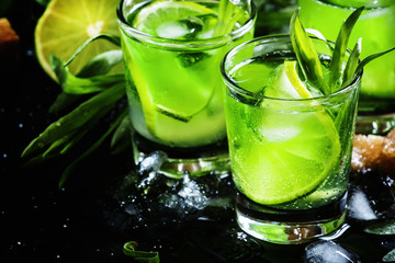 Alcoholic cocktail with lime green, lemon juice, cane sugar, sod