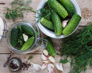 Cucumbers for pickling. Fresh cucumbers ready for canning with dill, garlic and spices.  Selective focus
