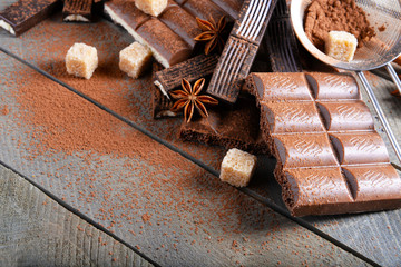 Chocolate sweets with powder on wooden background